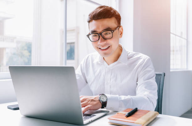 istock Young Asian businessman working at office 1384110701
