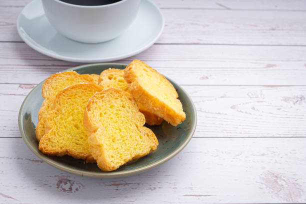 istock Crispy butter toast and a white coffee cup on wooden table 1384111147