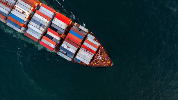istock Container ship carrying container import export, Global business logistic and transportation by container ship in open sea, Aerial view container cargo vessel supply chain company freight shipping. 1384112093