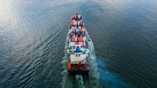 istock Container ship carrying container import export, Global business logistic and transportation by container ship in open sea, Aerial view container cargo vessel supply chain company freight shipping. 1384112106