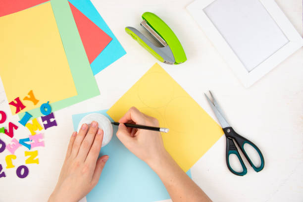 istock Butterflies with their own hands from colored paper. Step-by-step instructions, top view. Step 3. 1384113864