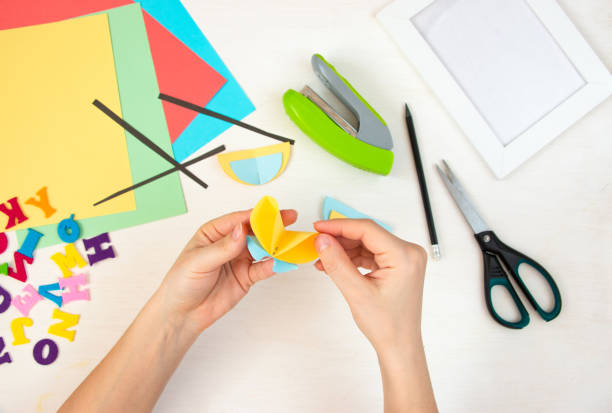istock Butterflies with their own hands from colored paper. Step-by-step instructions, top view. Step 15. 1384113882
