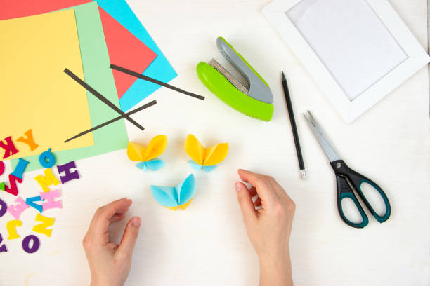 istock Butterflies with their own hands from colored paper. Step-by-step instructions, top view. Step 18. 1384113883