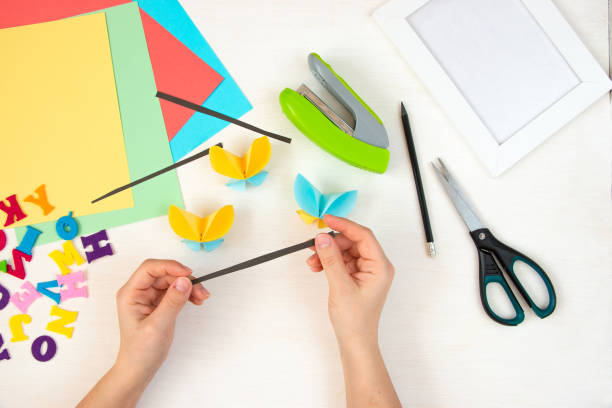 istock Butterflies with their own hands from colored paper. Step-by-step instructions, top view. Step 19. 1384114392