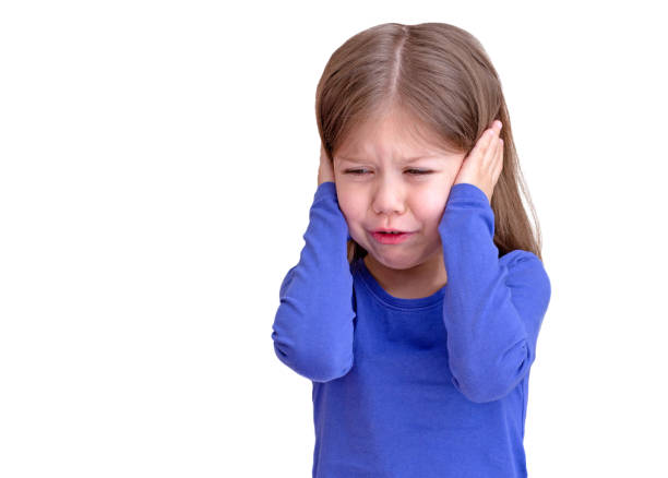 istock Crying child with tears on eyes closing ears by hands 1384116255