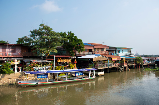 Life lifestyle of thai people at chaopraya riverside with boat and ship in fishing village for traveler travel visit at Sam Khok waterfront at Pathumthani on March 5, 2022 in Pathum Thani, Thailand