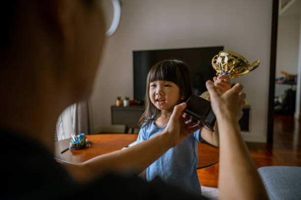 istock Daughter showing trophy to father 1384124936