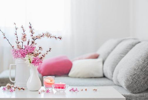 spring pink flowers in vase in white interior
