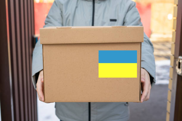 istock Delivery man holding cardboard boxes . Fast and free Delivery transport . 1384133387
