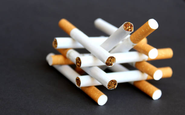 istock Cigarettes with a filter lie in one heap 1384133393