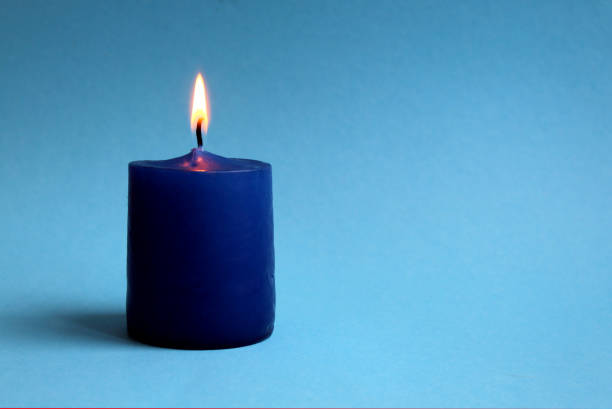 istock The candle burns on a blue background. 1384141068