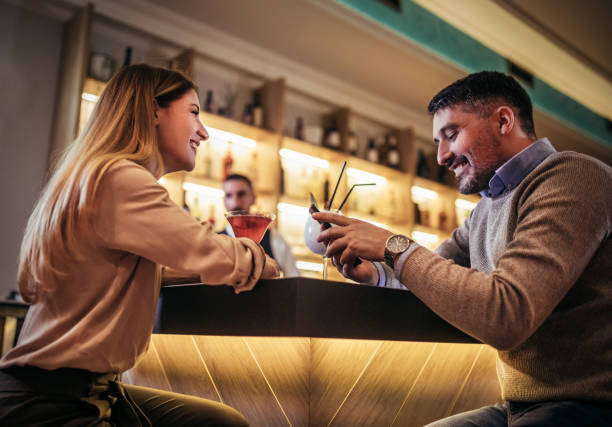 istock Young couple sitting at cafe counter 1384141080