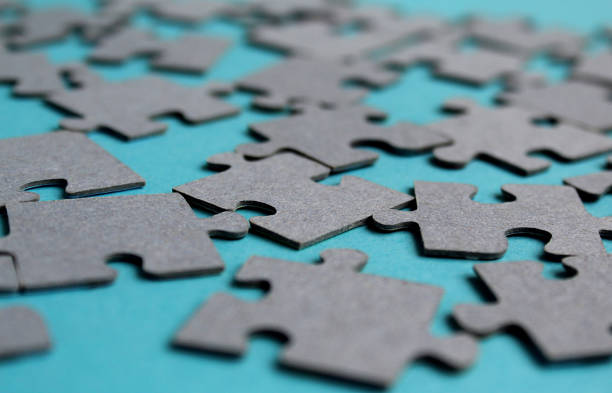 istock Puzzles lie loose on a turquoise background. 1384148233