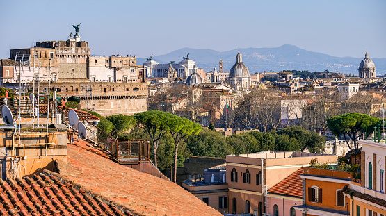 A suggestive cityscape on the roofs of the historic center of Rome from the Prati district. On the horizon, the domes of some Baroque style churches and the National Monument of the Altare della Patria (left). Prati is a historic and elegant quarter built at the end of the 19th century after the unification of Italy and the definition of Rome as the capital of the new nation, to host the growing population of the city and the state upper middle class. In 1980 the historic center of Rome was declared a World Heritage Site by Unesco. Super wide angle image in 16:9 and high definition format.