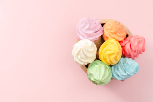 istock Various of colourful meringue ice cream cone on pink background 1384149656