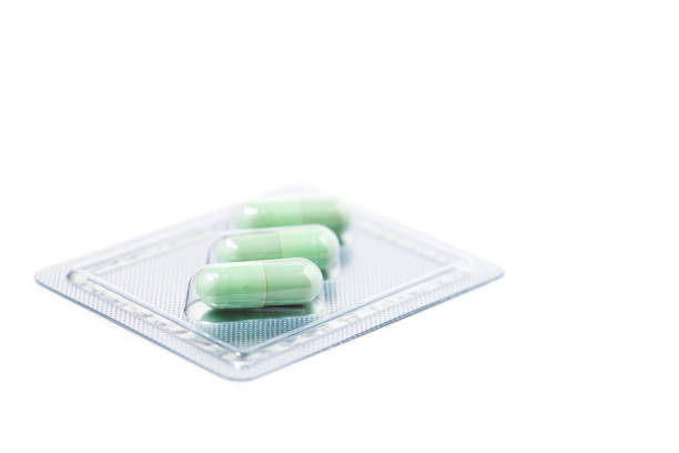istock Green chiretta herbal capsule on white background 1384149710