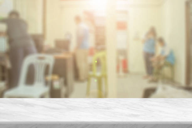 istock White stone marble table top and blurred abstract background from interior building banner backdrop with desk blur, counter work people in workplace, kitchen - can used for display or your products. 1384154427
