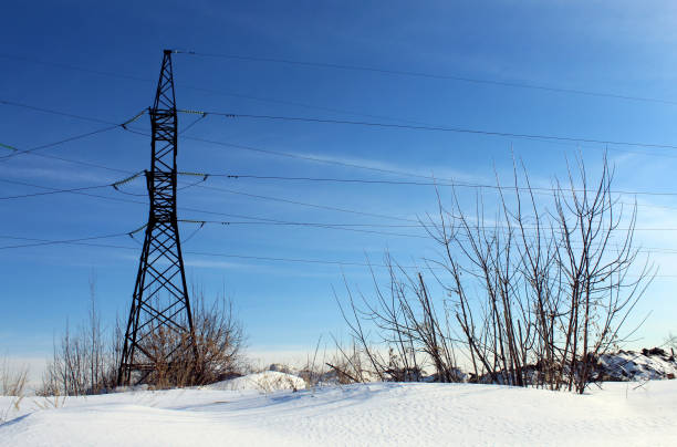 High voltage wires with an iron pole on a winter day.
