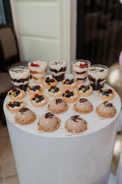 istock Sweet cakes in cups at a wedding buffet. Candy bar catering 1384154826