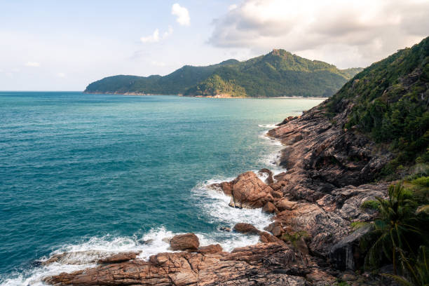 istock Wild place, stone shore, top view, turquoise sea waves at sunset 1384155334