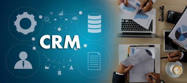 istock CRM Business Customer CRM Management Analysis Service Concept Business team hands at work with financial reports and a laptop 1384159878