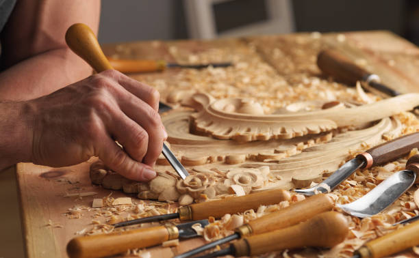 istock Man working with woodcarving instruments 1384160041