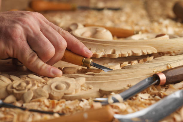 istock Wood carving, master's hand work with a wooden surface 1384160057