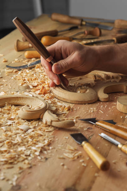 istock Man working with woodcarving instruments 1384160089