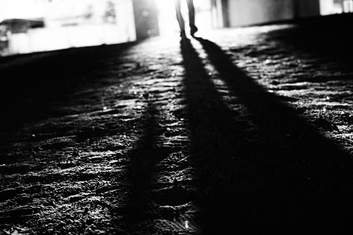 Image of silhouette and shadow of a person against the background of light
