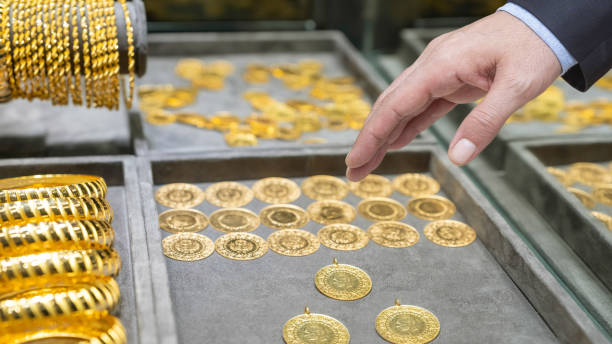 shopping man chooses gold coin - hand gold jewels bildbanksfoton och bilder