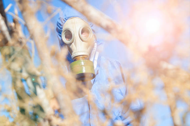 Environmental disaster. Post apocalyptic survivor in gas mask with a lab suit. science fiction concept. mid adult man