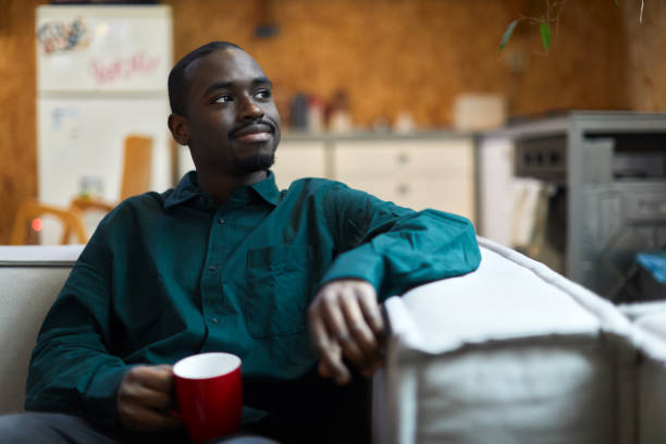 istock A young man is sitting at home drinking coffee. 1384176333