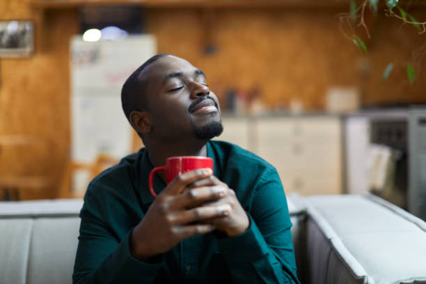 istock A young man is sitting at home drinking coffee. 1384176342