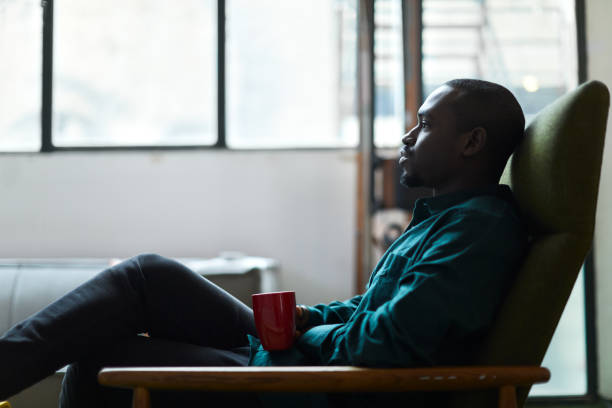 istock A young man is sitting at home drinking coffee. 1384176347