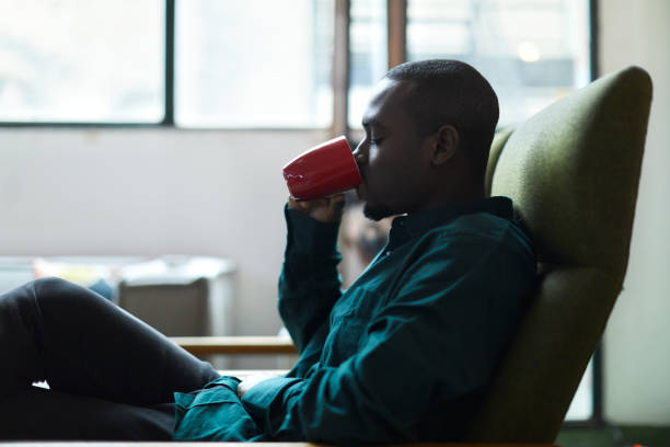 istock A young man is sitting at home drinking coffee. 1384176348