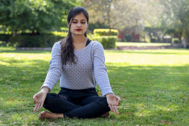 istock woman practices yoga and meditates. 1384176861