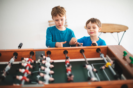 Brothers playing table soccer