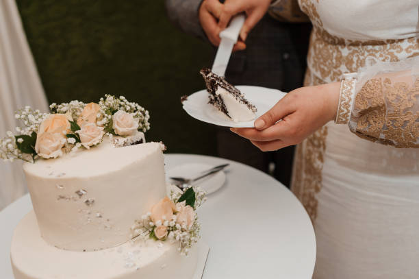 istock Beautiful wedding cake decorated with flowers, cake close up and blur background 1384202178