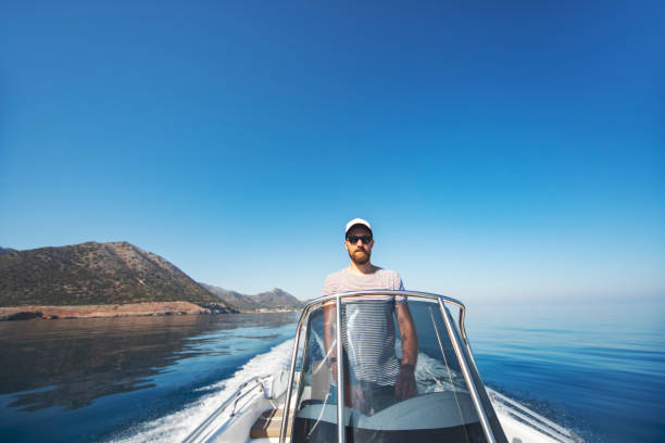 istock Young man riding on speedboat 1384202984