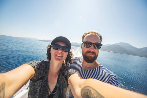 istock Young couple selfie at speedboat travel 1384202993