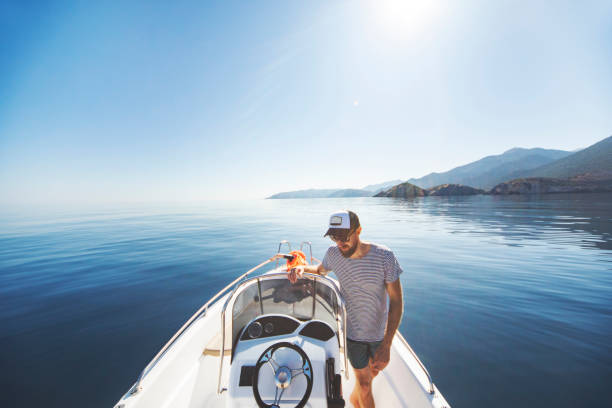 istock Young man riding on speedboat 1384203004