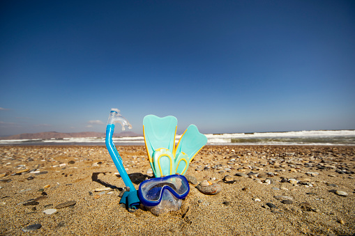 Flipper, snorkel mask and snorkel  at the beach