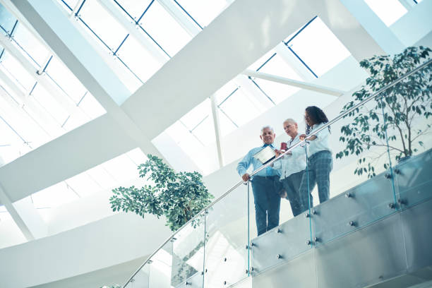 group of business people standing on the balcony of a business center stock photo