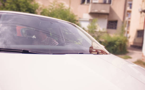 istock Handsome young Man parking the car 1384207598