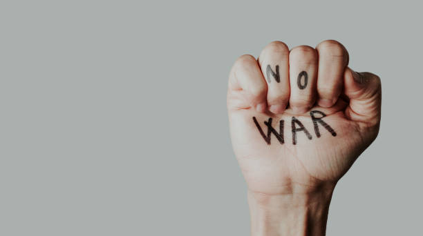 istock clenched fist with the text no war written in it 1384207626
