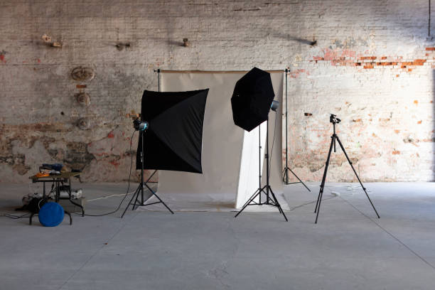 istock Photo Studio Lighting Set up with Gray Backdrop in Brick Wall Hangar 1384207830