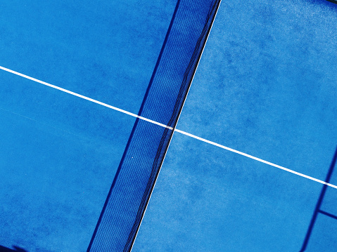 Aerial drone view of blue paddle tennis court