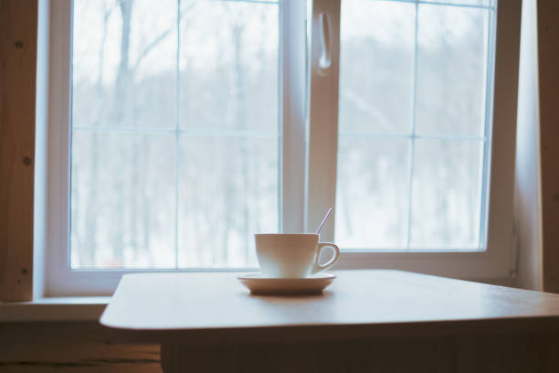 istock A cup on the table in front of the window. 1384207991