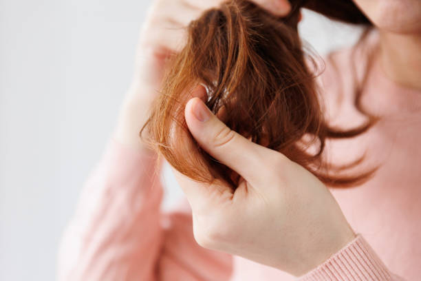 istock close up of a woman hands with hair problems. 1384208034