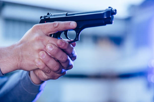 istock Policeman aiming a handgun towards the target 1384208546